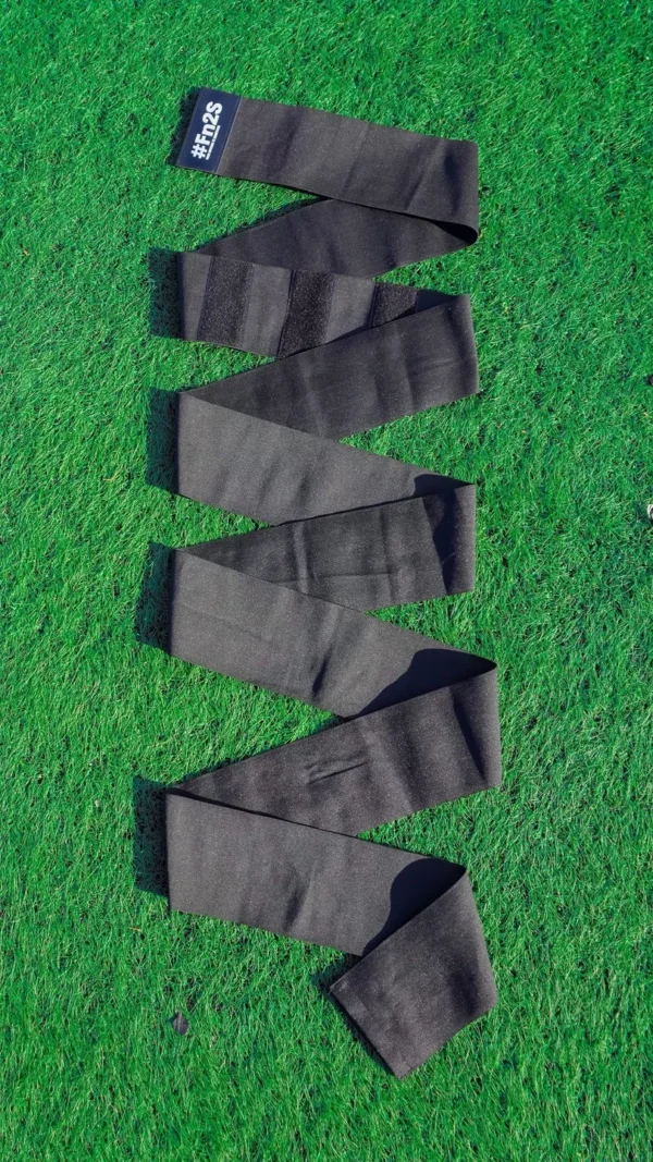 A green field with some black socks on it