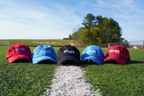 A row of hats sitting on top of a grass covered field.