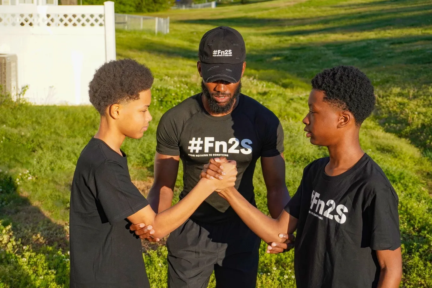 three people wearing black Fn2S T Shirts